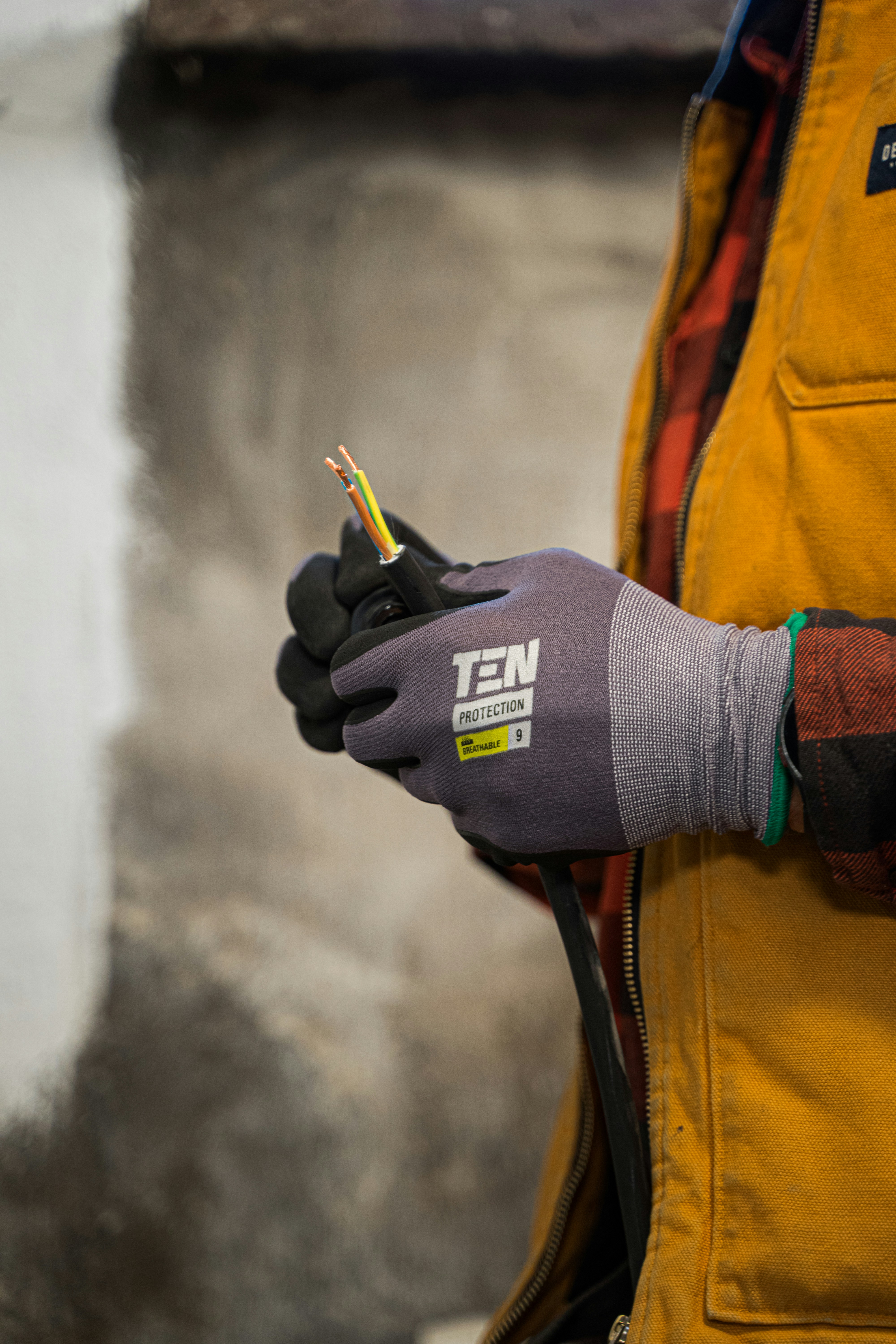 Elektricien met een elektrische kabel in de hand